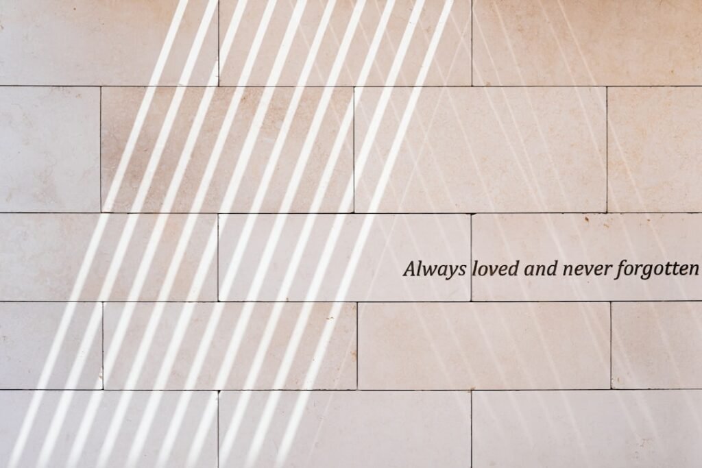A wall with a quote on it that says always loved and never forgotten