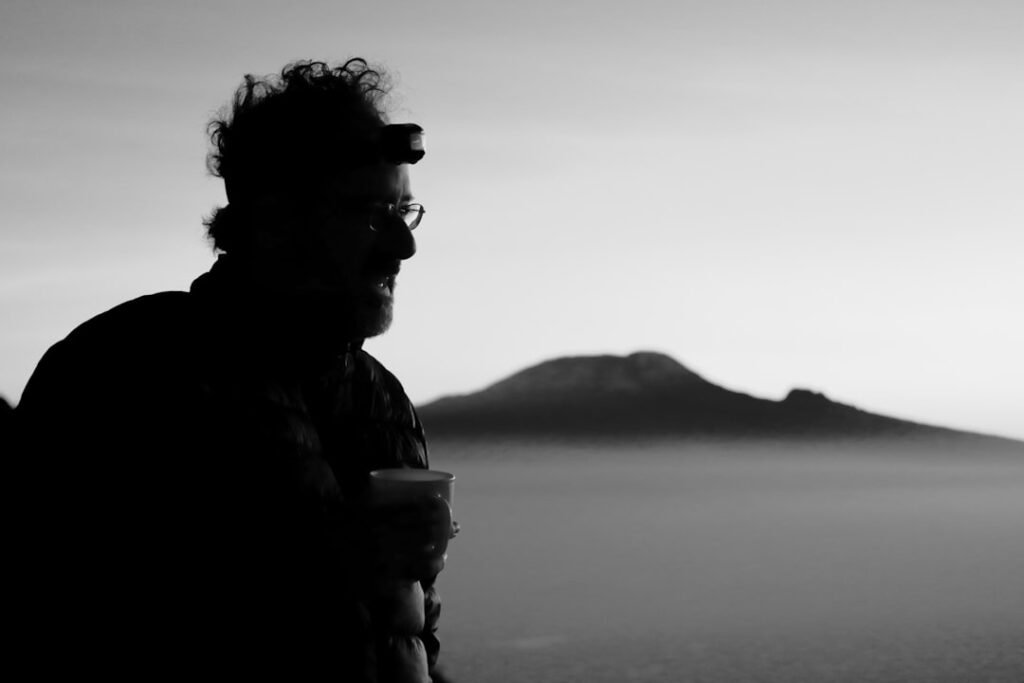 Man enjoys the view of a distant mountain.