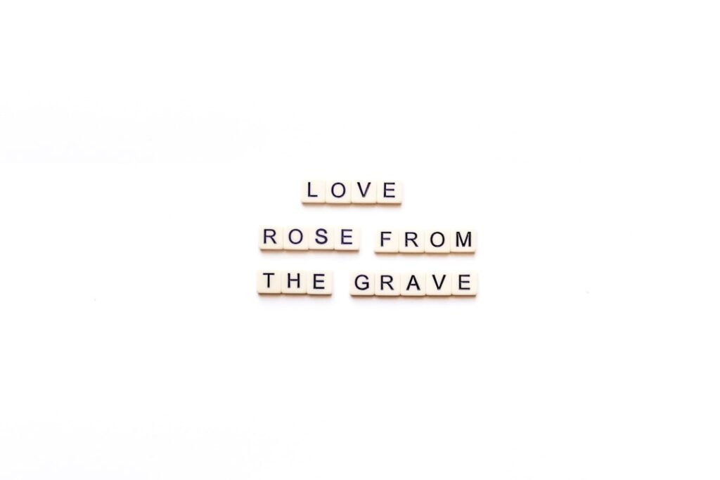the words love, rose from the grave are spelled in scrabble