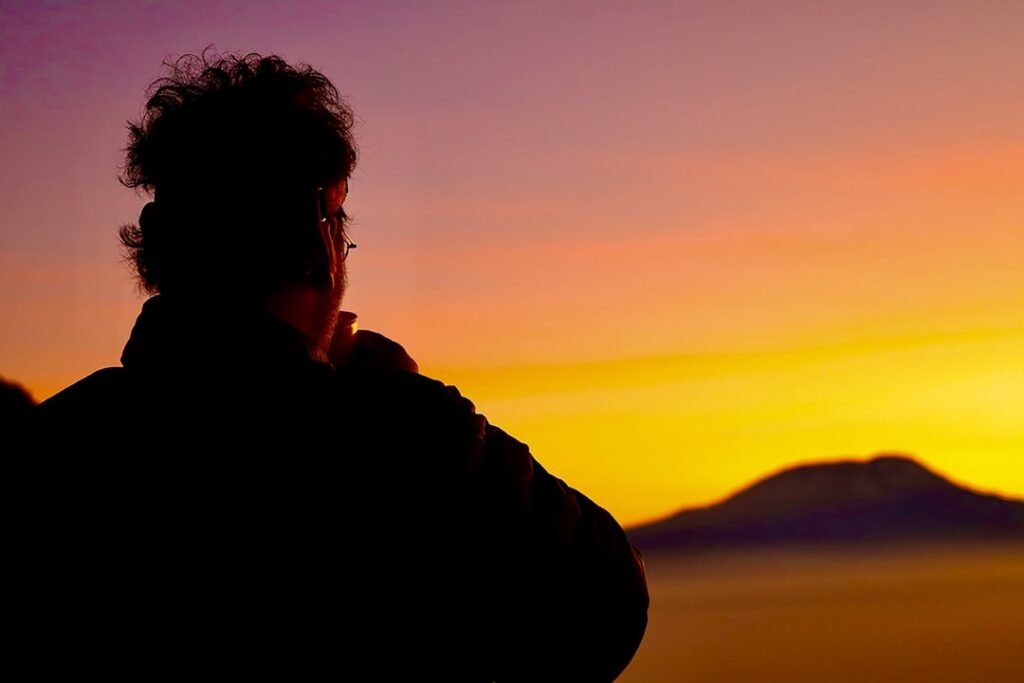 A person standing in front of a sunset