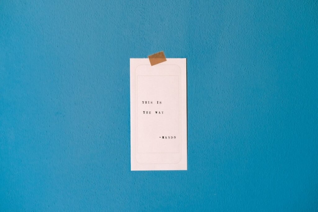 white printer paper on teal wall